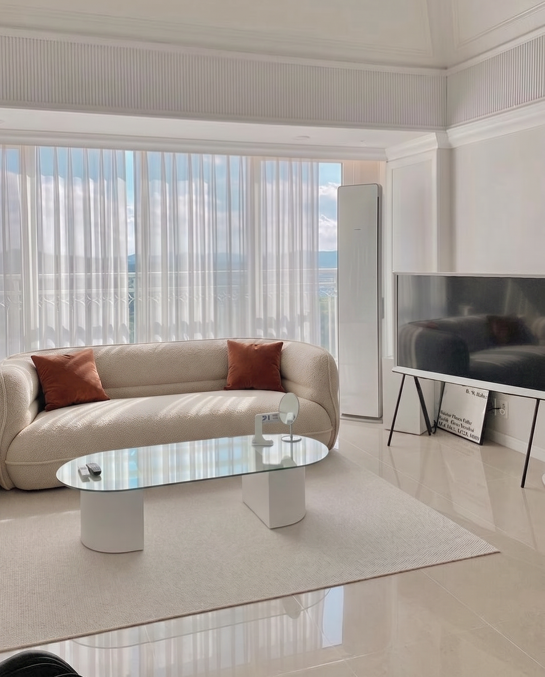 Lune Bouclé Crescent Sofa in a warm apartment living room with cream bouclé texture and accent pillows