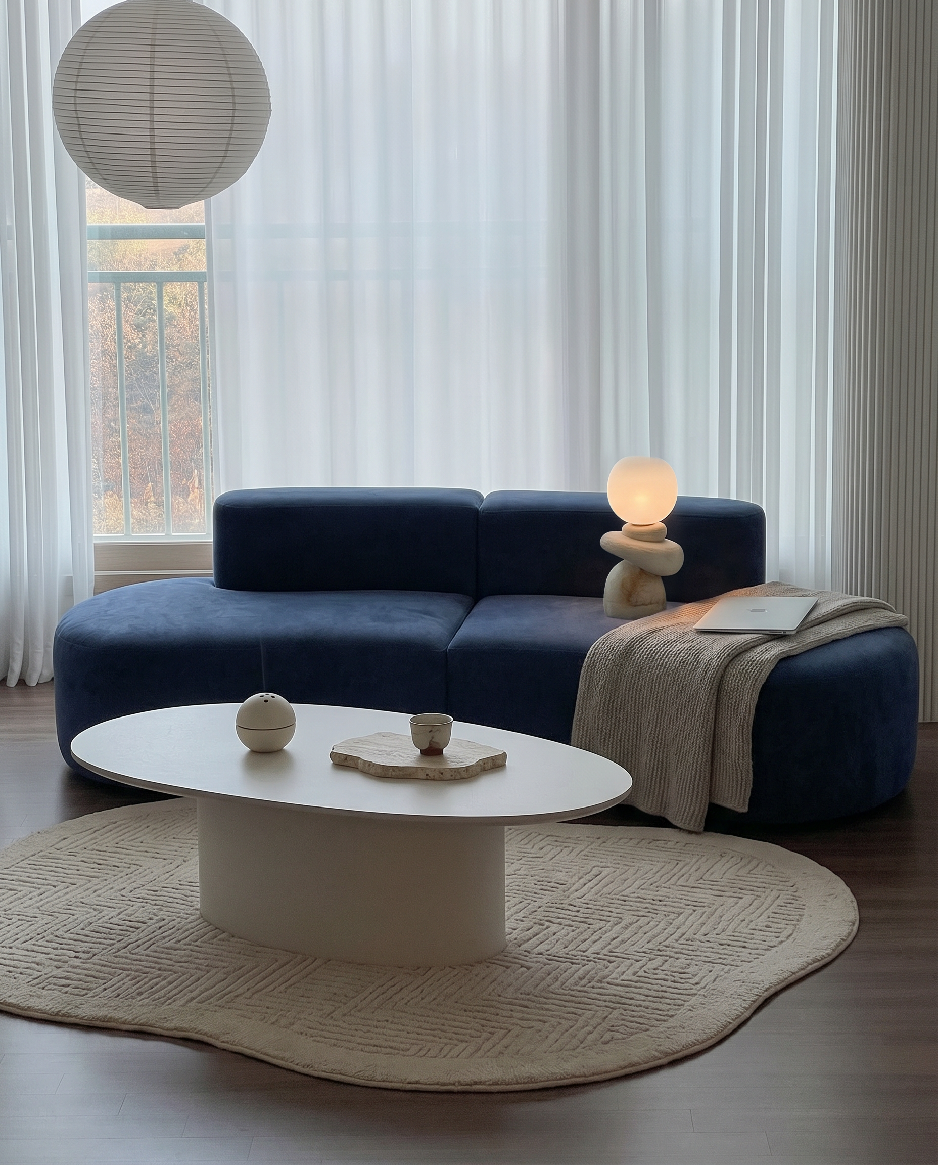 Casia Navy Wave Lounge Sofa styled as a sculptural centerpiece in a large living space