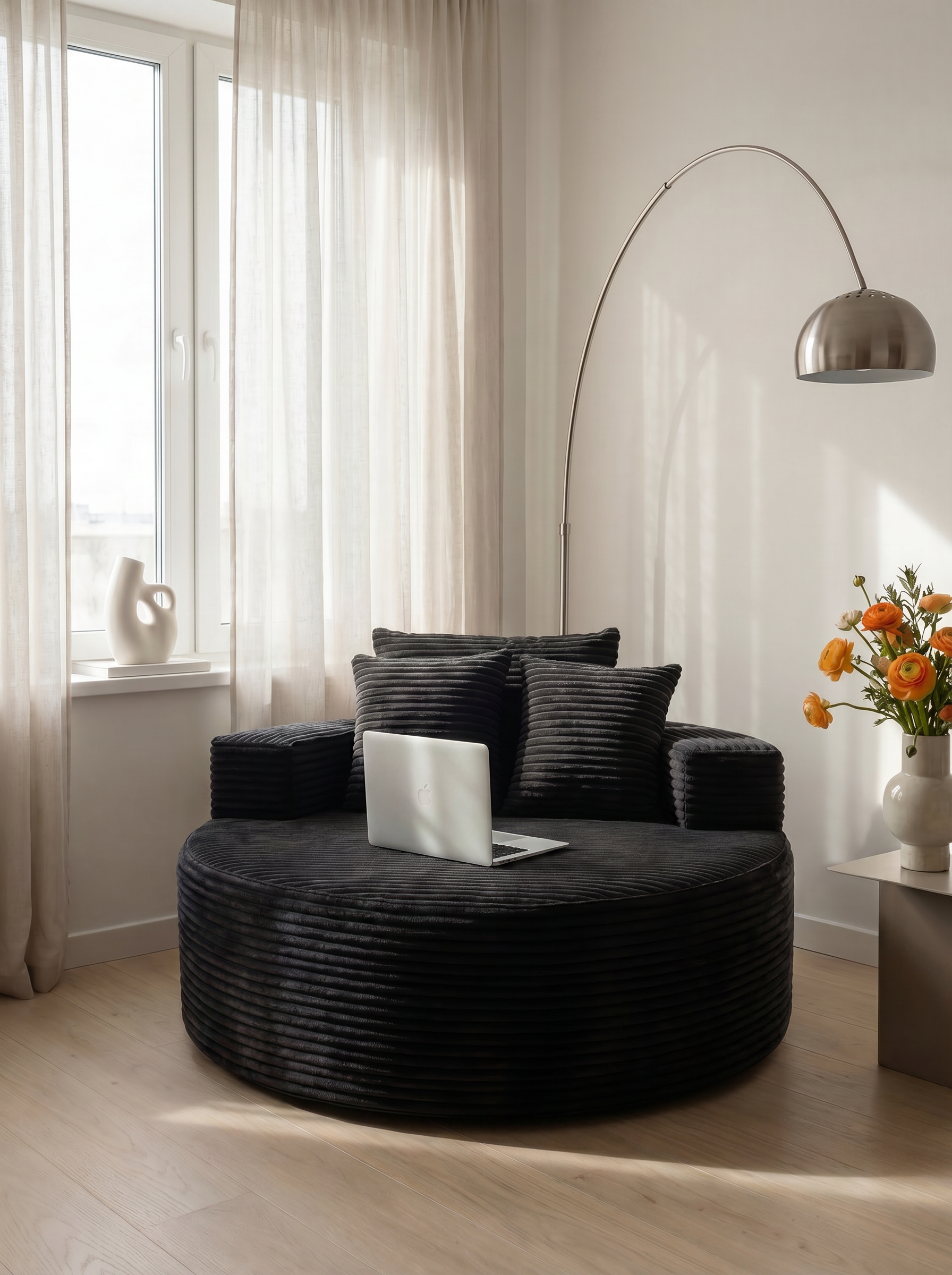 Noma Charcoal Deep Lounge Chair styled as a cozy personal lounge space with a laptop
