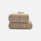 Side view of Aven Sculptural Offset Sofa with offset silhouette and rounded shape