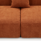 Burnt orange corduroy seat cushion and pillow detail on Plush Accent Lounge Loveseat