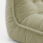 Lune Cream Lounge Chair in Moss with curved backrest and padded seat detail