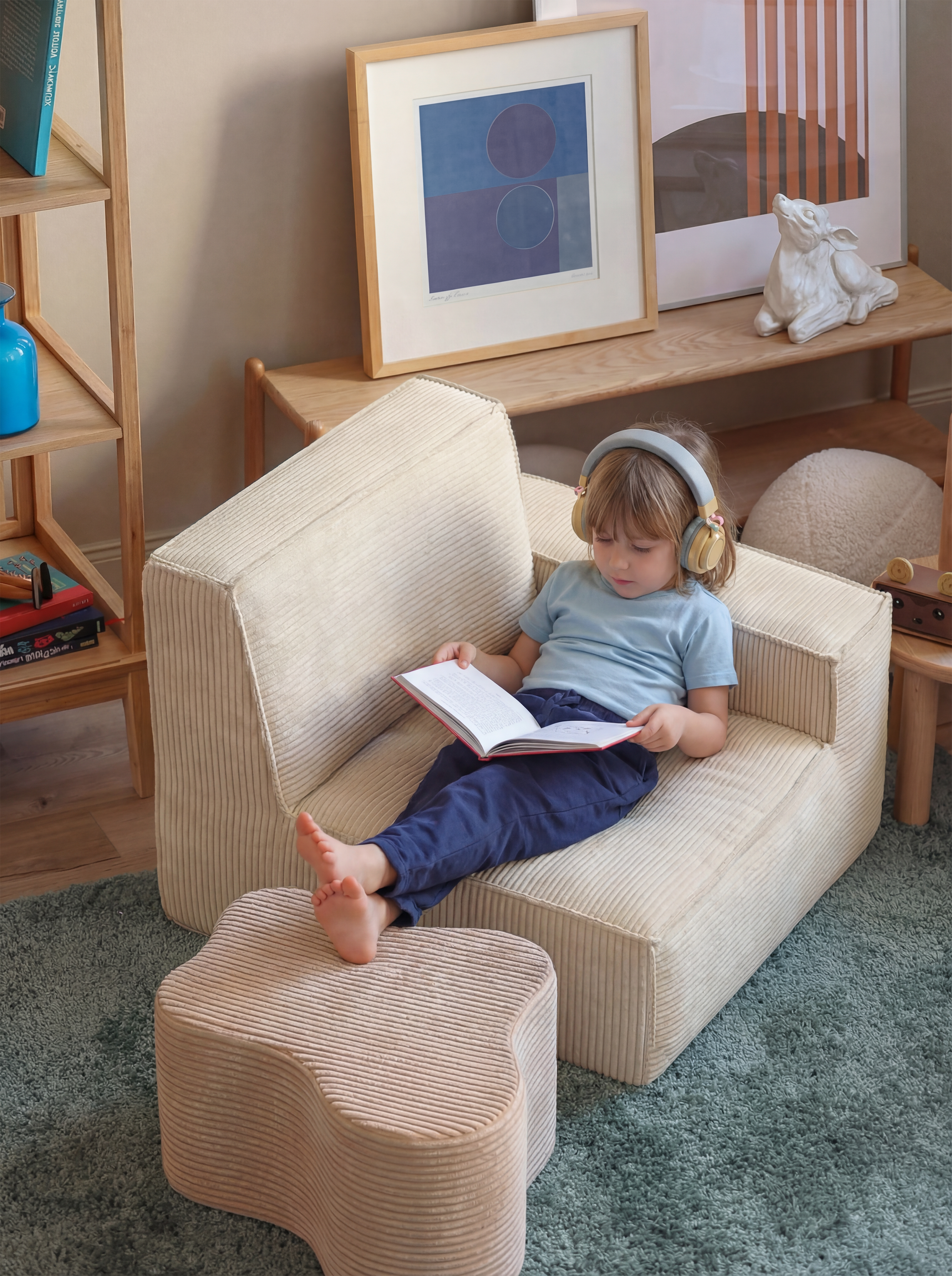 Kivo Modular Sofa cream module styled as a cozy kids reading chair