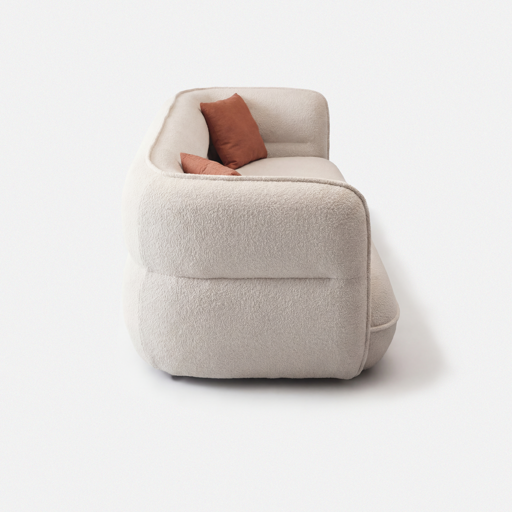 Lune Bouclé Modular Curved Sofa side view with rounded armrest and cream white textured upholstery