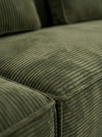 Close-up of Aero deep-seat sofa cushion with soft forest green corduroy upholstery