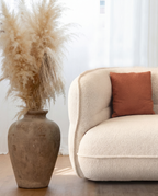 Lune Bouclé Modular Curved Sofa with cream textured upholstery styled in a soft natural living space