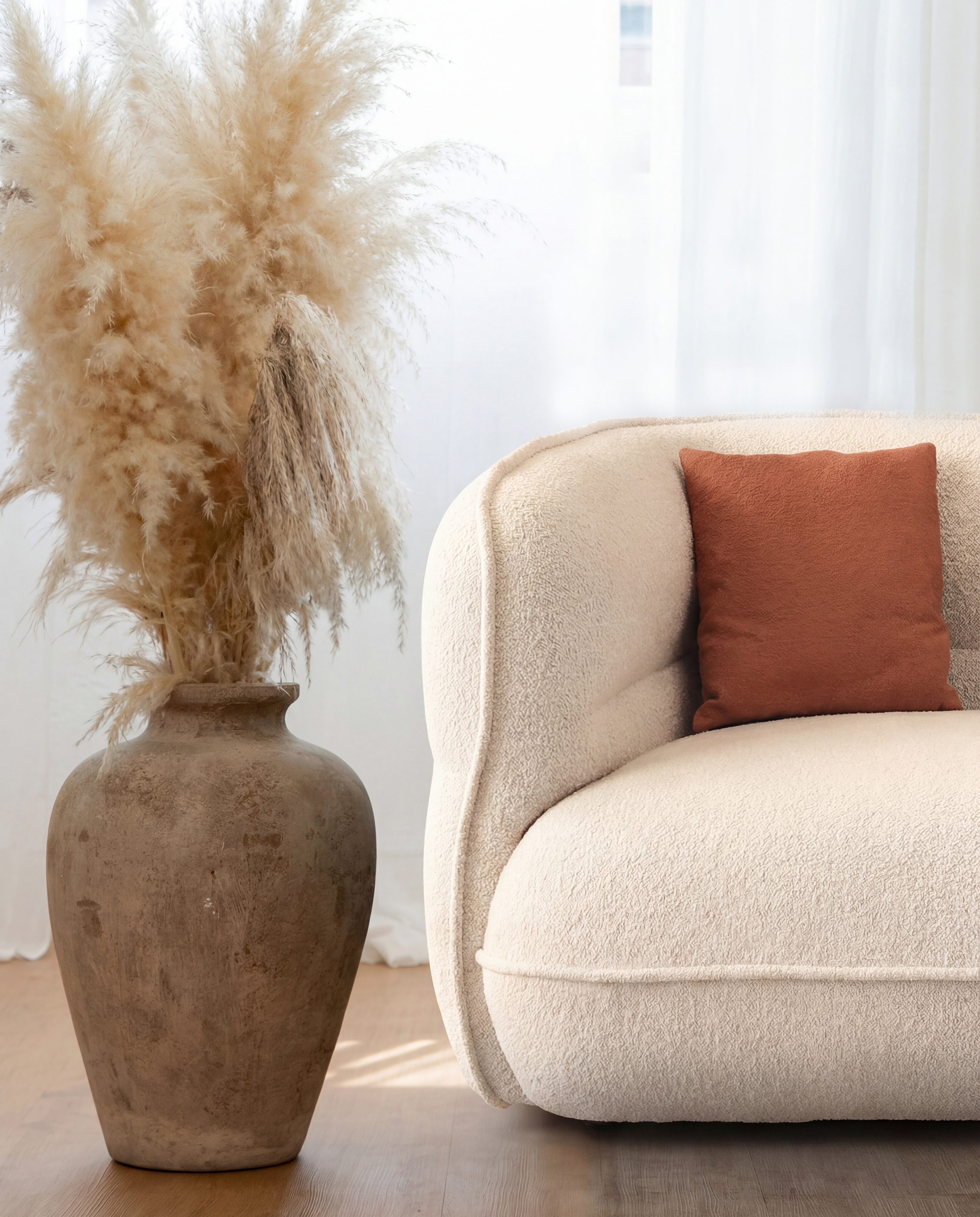 Lune Bouclé Modular Curved Sofa with cream textured upholstery styled in a soft natural living space