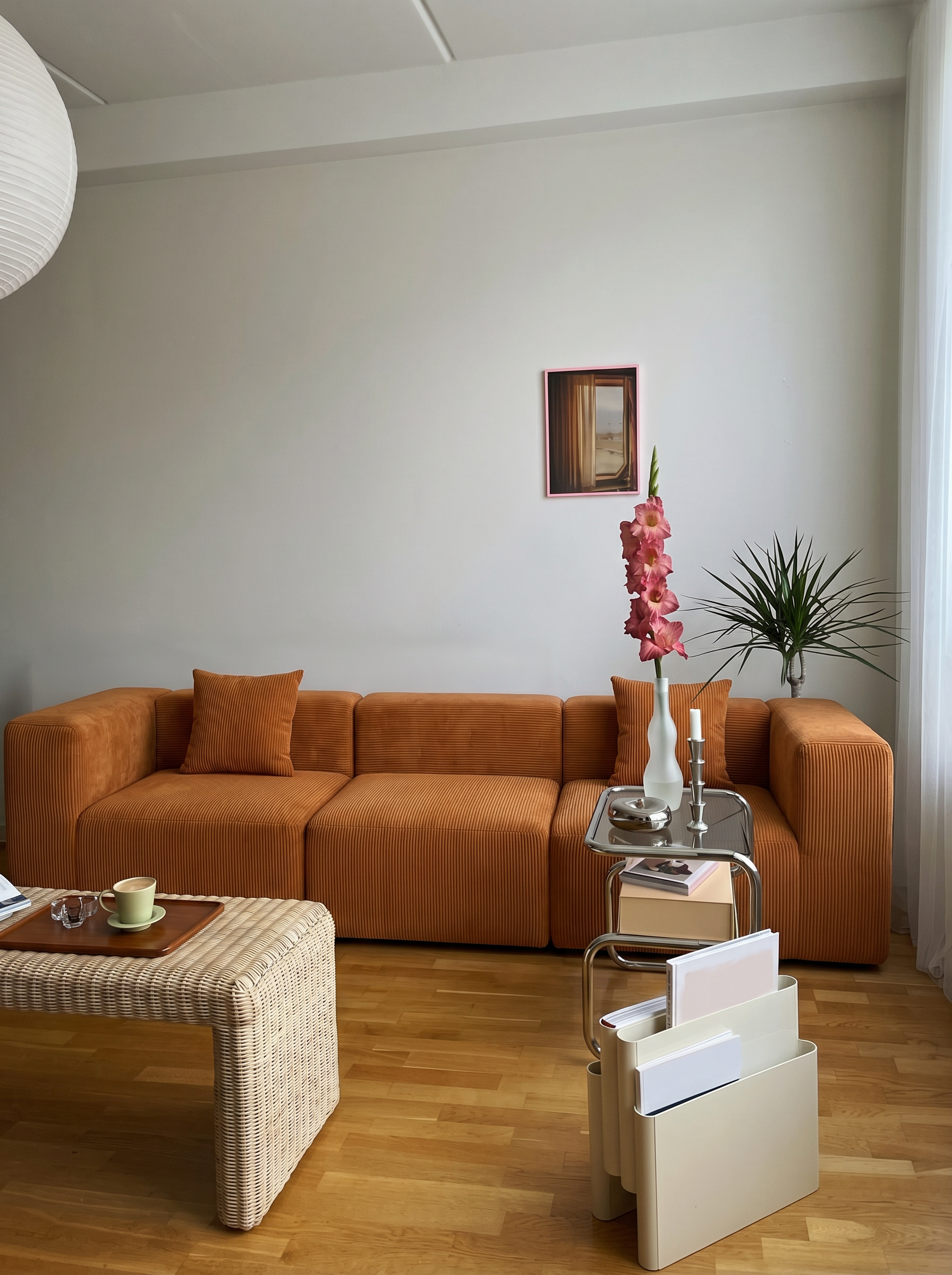 Burnt orange corduroy loveseat styled as a cozy centerpiece in a modern living room