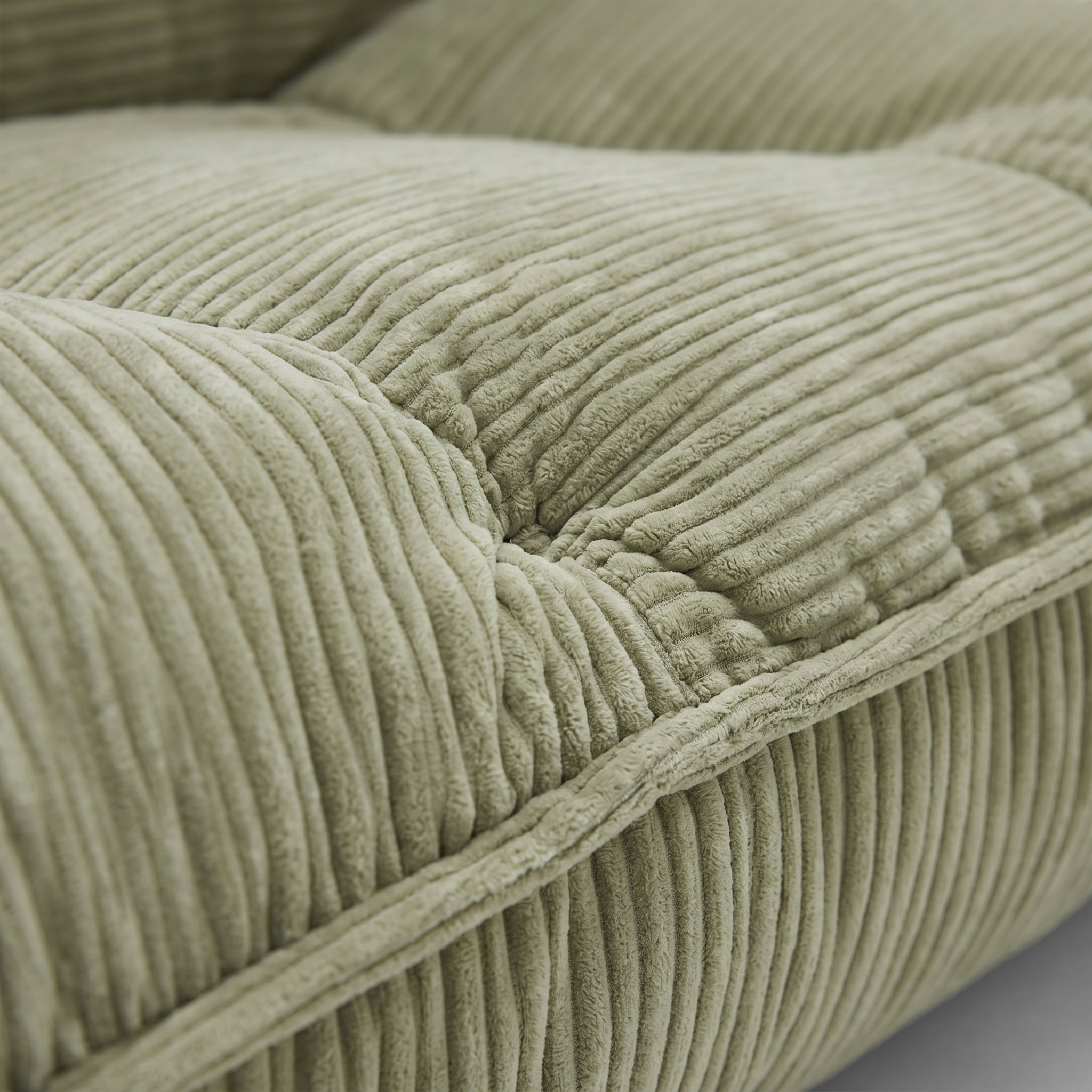 Lune Cream Lounge Chair in Moss with plush corduroy seat and seam detail