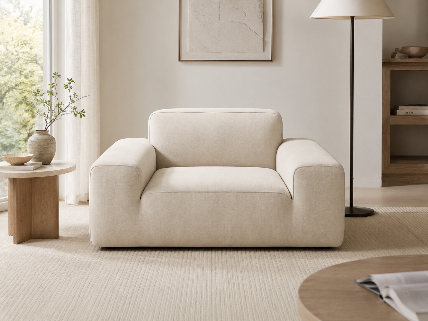 Tovo Wide Accent Chair in Cream White styled as a soft accent piece in a calm living room