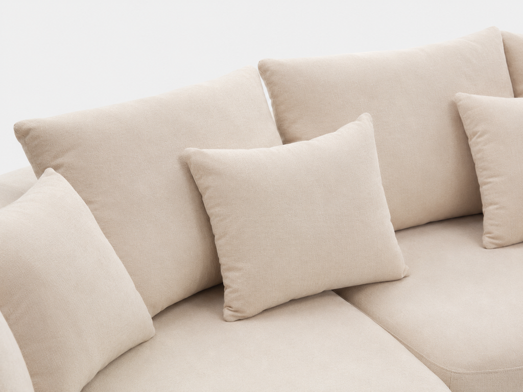 Cove Curved Sleeper Sofa cushion and pillow detail with soft cream upholstery