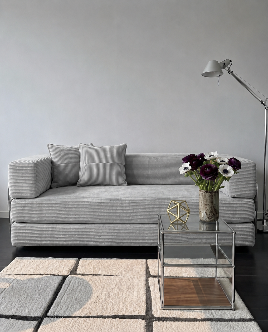 Milo Corduroy Sleeper Sofa in Light Grey styled in a modern living room with glass side table and floor lamp