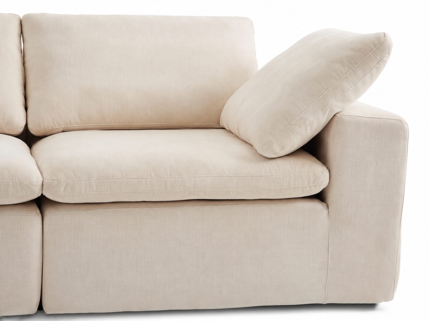 Aero modular sofa close-up showing wide armrest, pillow, and textured linen-cotton fabric