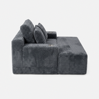 Side view of the Lune Charcoal Compact Chaise Lounge showing its deep seat, angled back cushions, and built-in cup holders