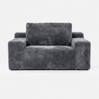 Side view of the Lune Charcoal Compact Chaise Lounge showing its deep seat, angled back cushions, and built-in cup holders