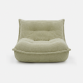 Lune Cream Lounge Chair in Moss with curved lounge design and plush corduroy texture