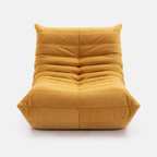 Noma Floor Lounge Chair in Yellow with low-profile pleated design and soft cushioned upholstery