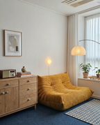 Noma Floor Lounge Chair in Yellow styled in a warm reading corner