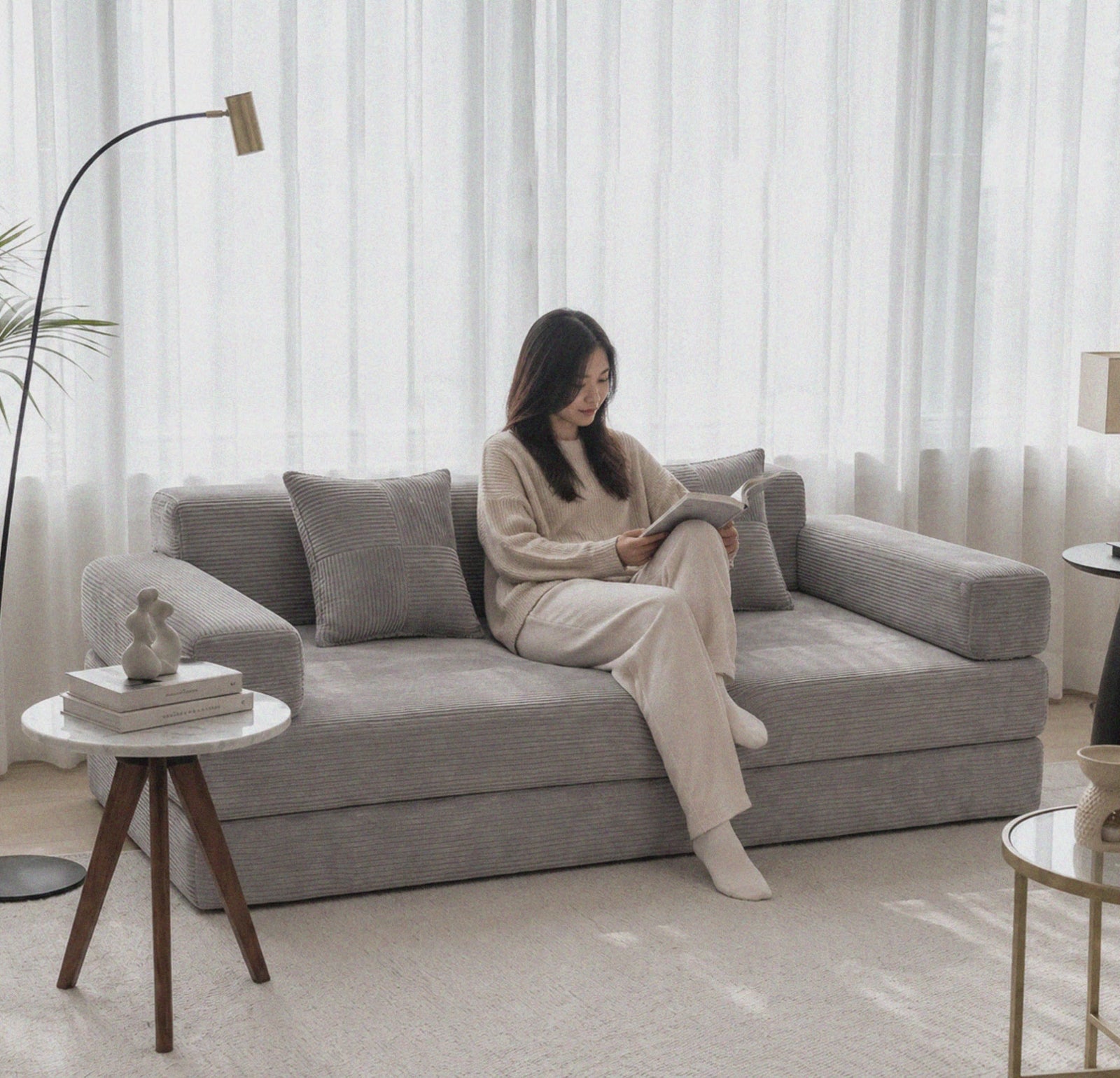 Milo Corduroy Sleeper Sofa in Light Grey styled for quiet reading and relaxed everyday lounging